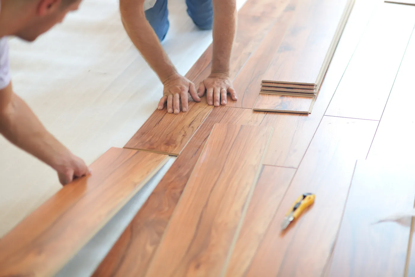 Installer laying timber floorboards