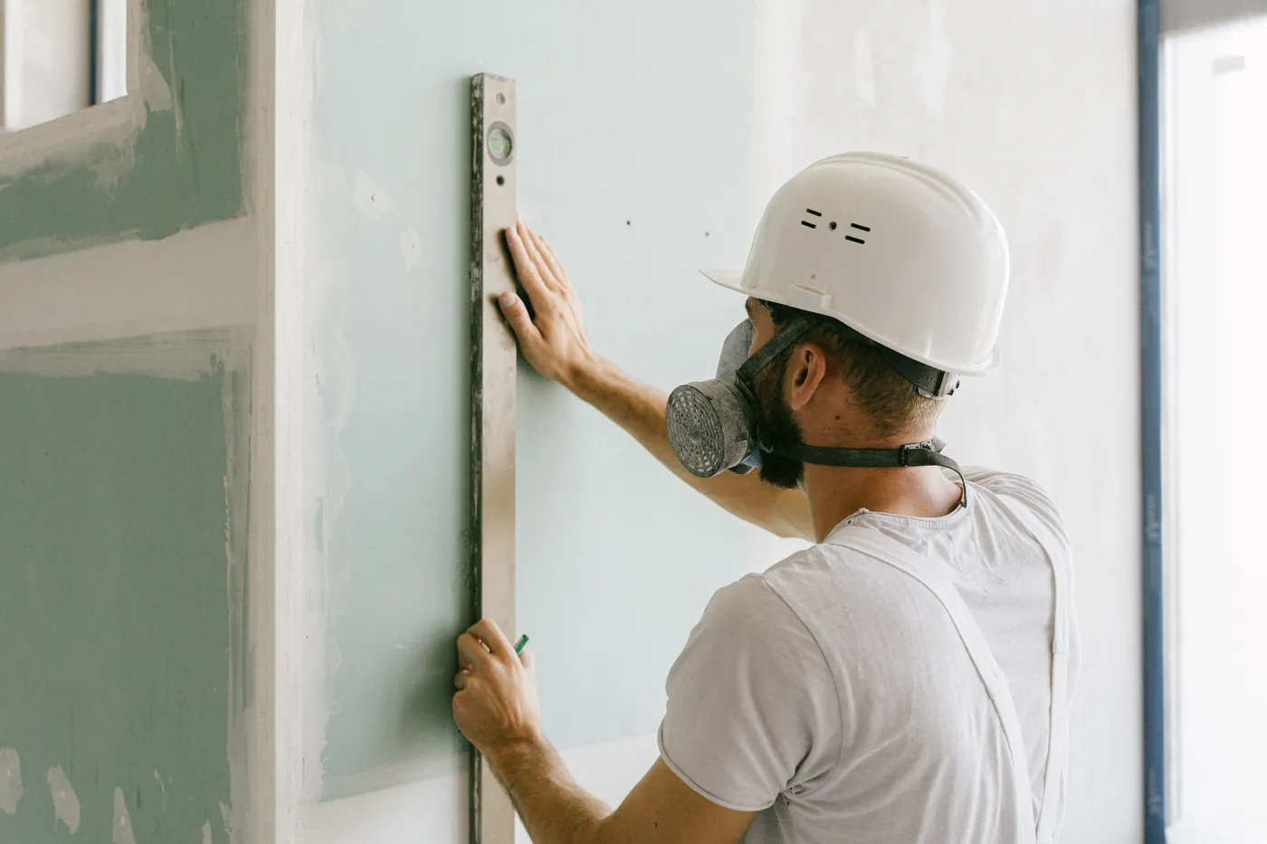 Painter levelling a wall before painting